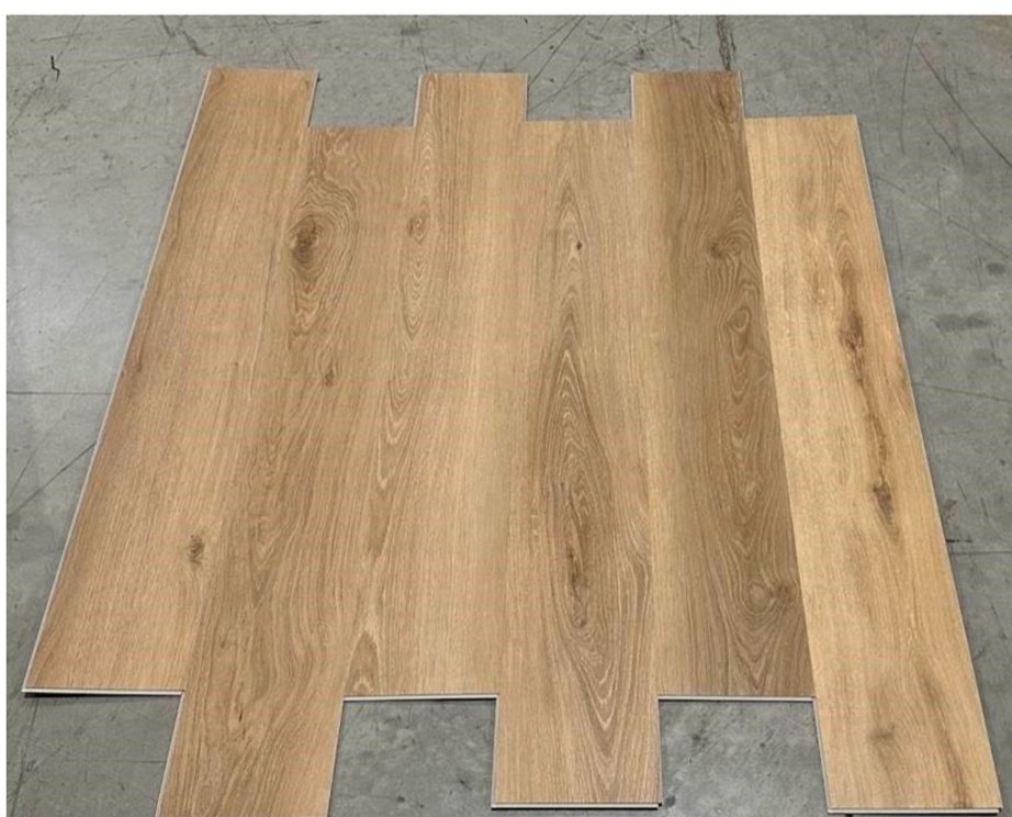 Natural Oak waterproof LVP planks clicked together, showing mid-tone golden oak graining