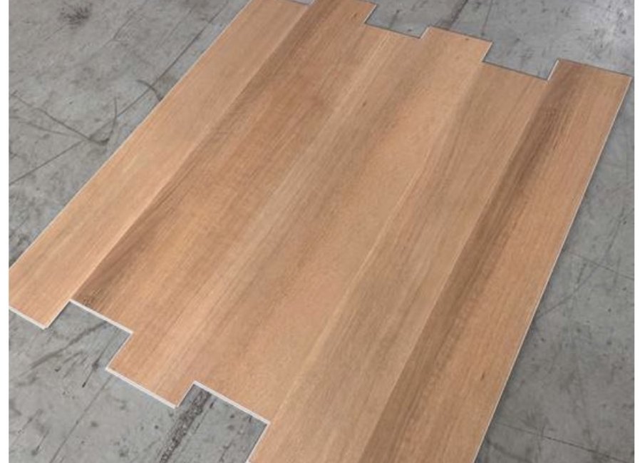 Honey Oak waterproof LVP planks clicked together, showing a smooth warm honey-toned surface